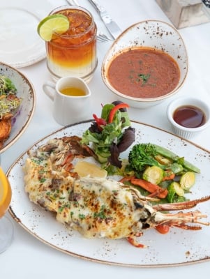 A table with lobster, fish chowder and a Gosling's Dark n Stormy.