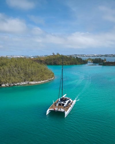 An aerial view of the great sound with a large catamaran in the middle.